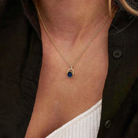 Arched Frame Blue Oval Spinner Pendant Necklace