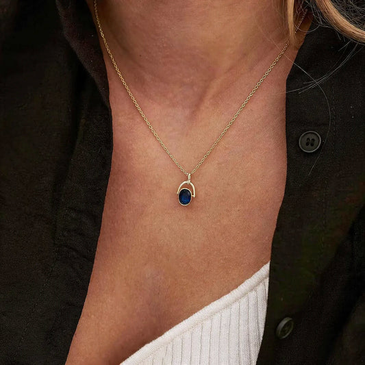 Arched Frame Blue Oval Spinner Pendant Necklace
