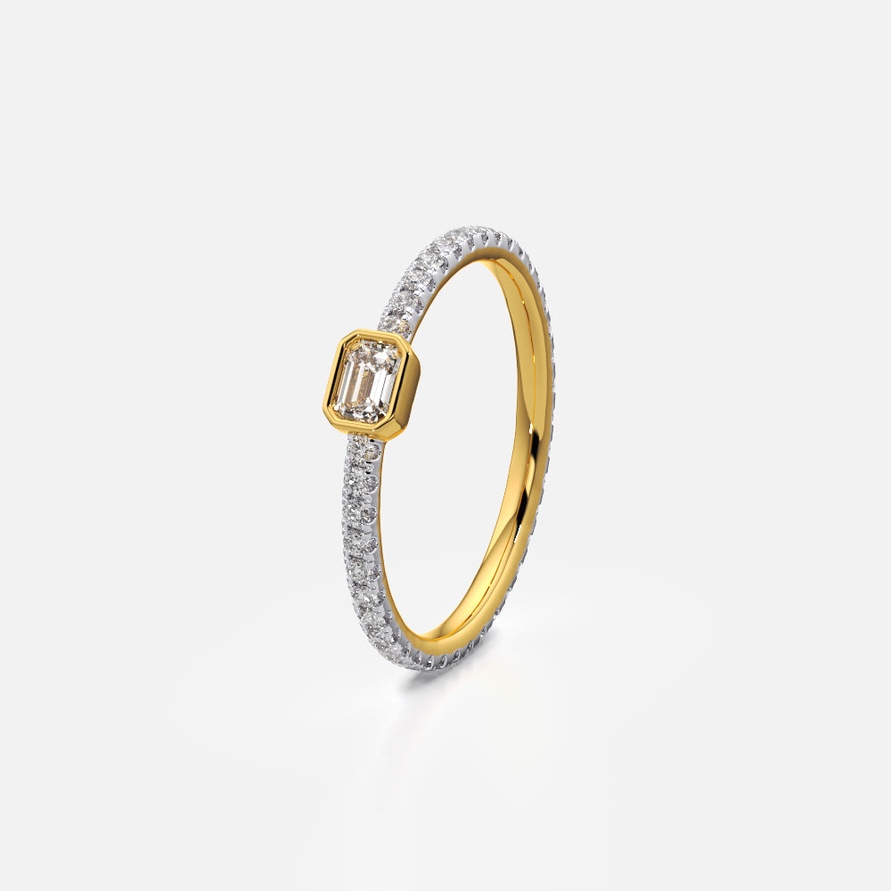 Bezel-set emerald solitaire ring with slim eternity band