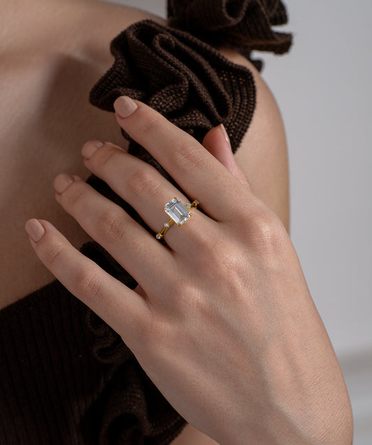 Emerald Cut Solitaire Ring with Scattered Stone Band