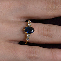 Blue Oval Centre Ring with Cluster Side Stones