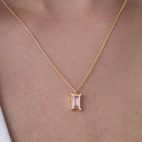 Gold vermeil necklace with a pink gemstone pendant on a person's neck